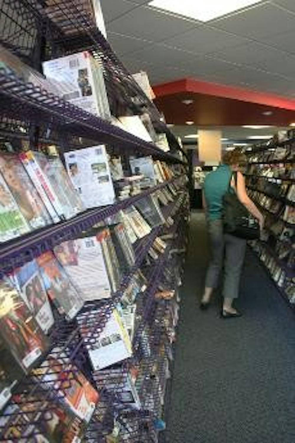 MOVIE SELL OUT - People browse the emptying shelves at Hollywood Video in Tenleytown. All movies and merchandise are being sold for low prices. The store will be closing in the near future because the cost of the building's rent recently doubled.
