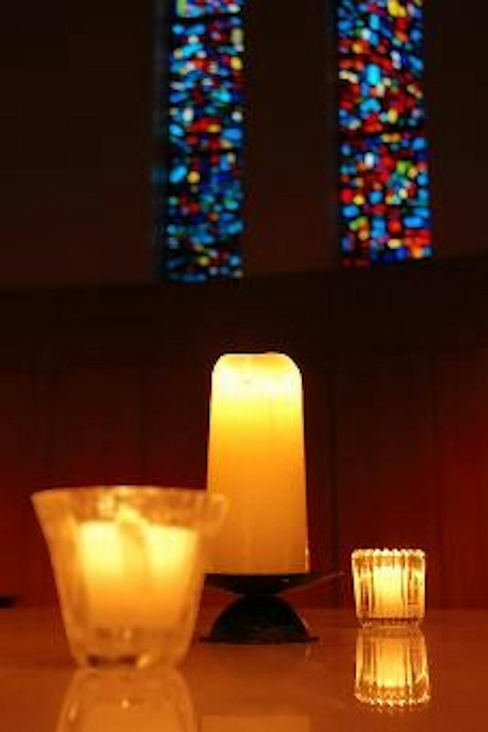 LIGHTING THE WAY - Candles illuminate the inside of the Kay Spiritual Life Center during a vigil Monday honoring victims of the NIU shooting spree.
