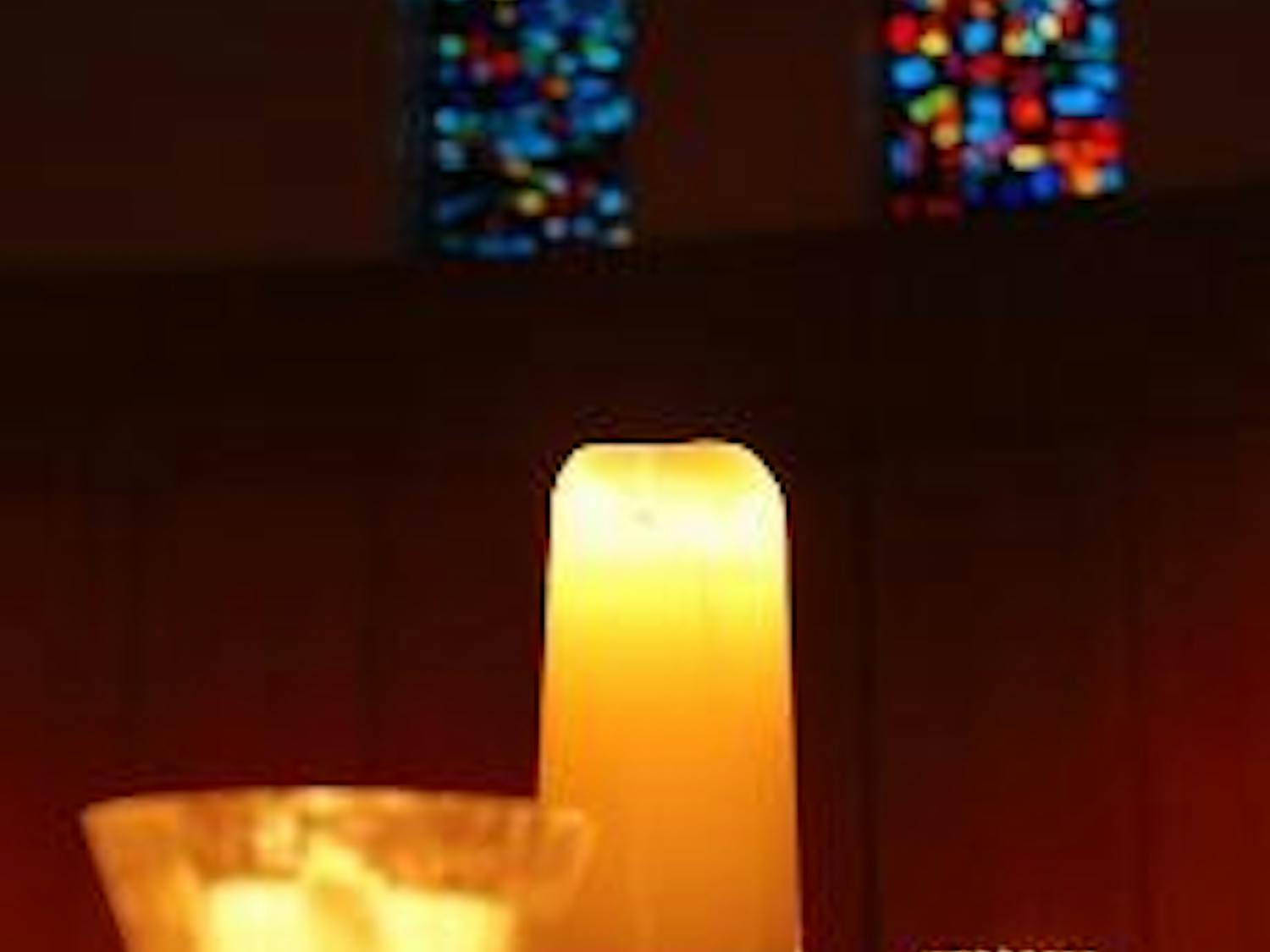 LIGHTING THE WAY - Candles illuminate the inside of the Kay Spiritual Life Center during a vigil Monday honoring victims of the NIU shooting spree.
