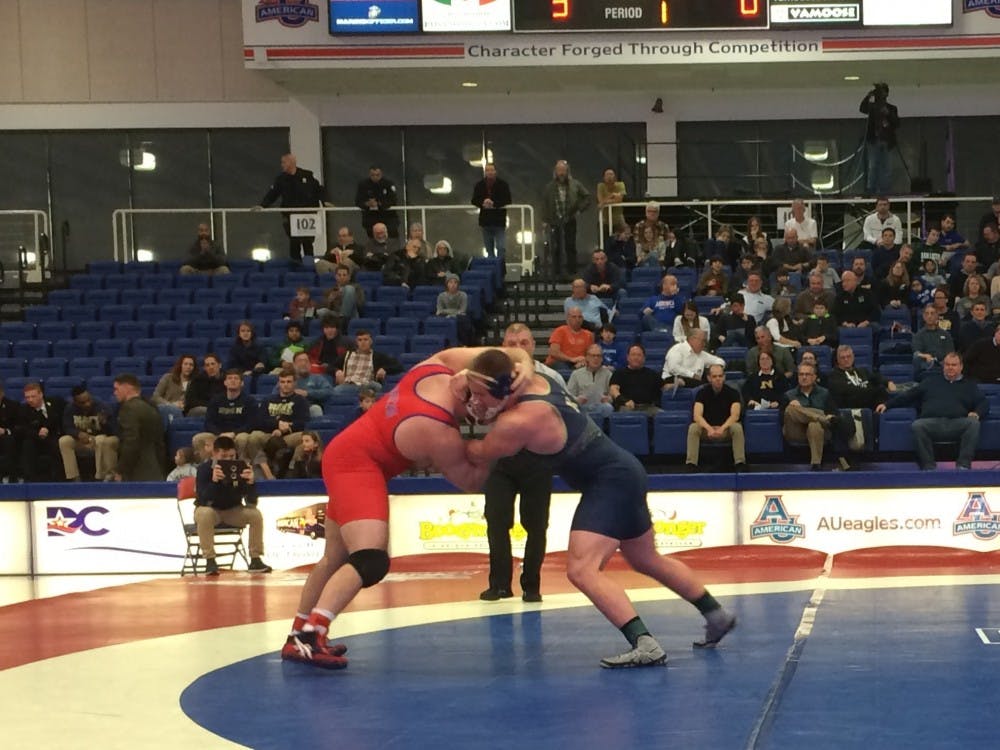 Redshirt senior heavyweight Brett Dempsey (red) locks up with&nbsp;Navy's Austin Faunce during the Eagles' 25-9 loss to the Mids. Dempsey was one of three AU wrestlers to earn individual victories.&nbsp;