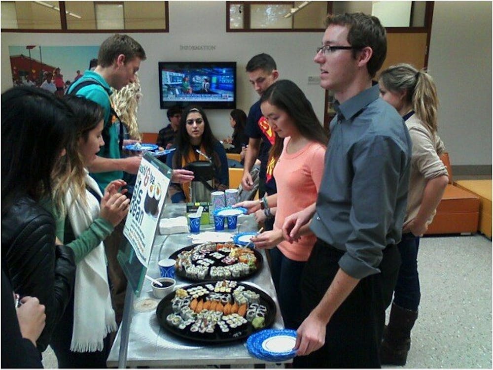 	SIS student council members serve students lined up for “Sushi and Tea” with the SIS Associate Dean Patrick Jackson on Oct. 23.