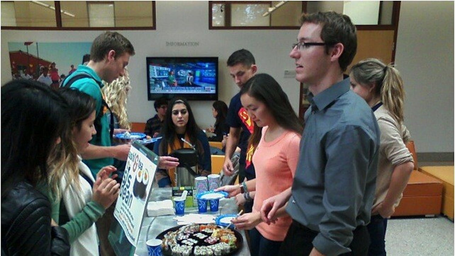 	SIS student council members serve students lined up for “Sushi and Tea” with the SIS Associate Dean Patrick Jackson on Oct. 23.