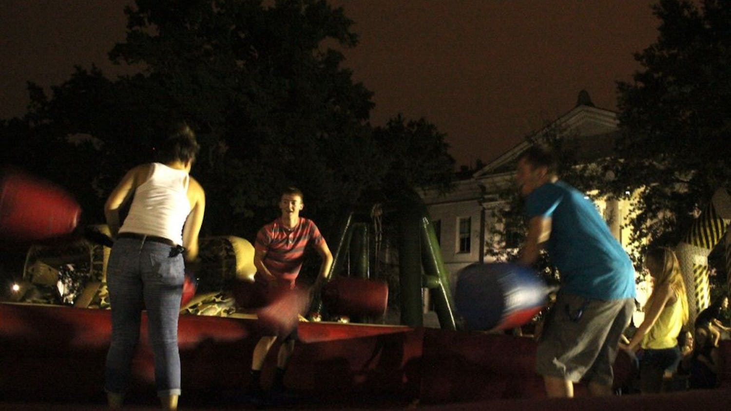 	Students battle each other with pugil sticks, one of many games provided during Quad After Dark.