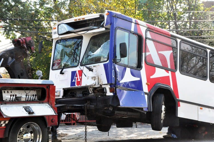 The AU shuttle that struck a utility pole is towed from the scene.