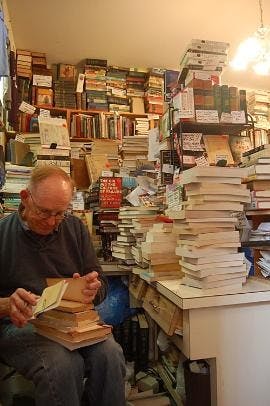 NEW CHAPTER - Capitol Hill Books owner Jim Toole, 71, rings up a customer's purchases. Toole's property taxes have increased 150 percent over the past three years, a result of gentrification in the neighborhood.