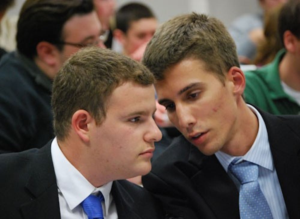 PLANNING THE DEFENSE -- Respondent Matt Handverger confers with his special counsel, Tommy Fijacko, during the Tuesday night segment of Handverger\'s impeachment proceedings. 