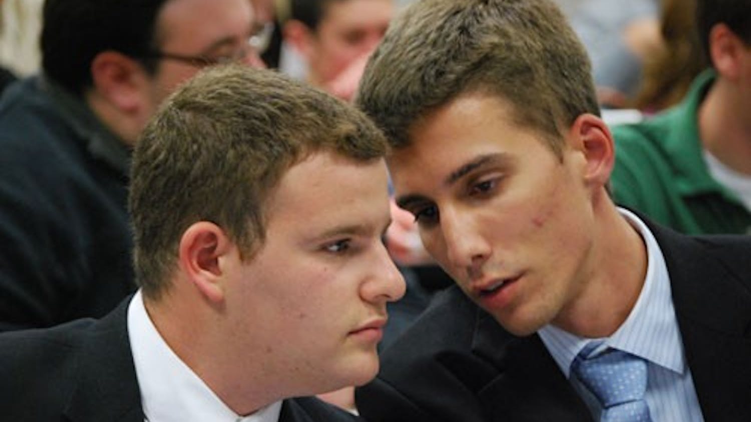 PLANNING THE DEFENSE -- Respondent Matt Handverger confers with his special counsel, Tommy Fijacko, during the Tuesday night segment of Handverger\'s impeachment proceedings. 