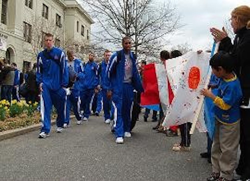 RALLYING FOR THE TEAM - Students, faculty, staff and members of the community cheer on the AU men\'s basketball team in front of Mary Graydon Center. The team departed for their first-ever NCAA tournament appearance in Birmingham, Ala., yesterday following