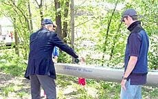 Pierre Han christens the new boat, which was renamed "Sweet Caroline."