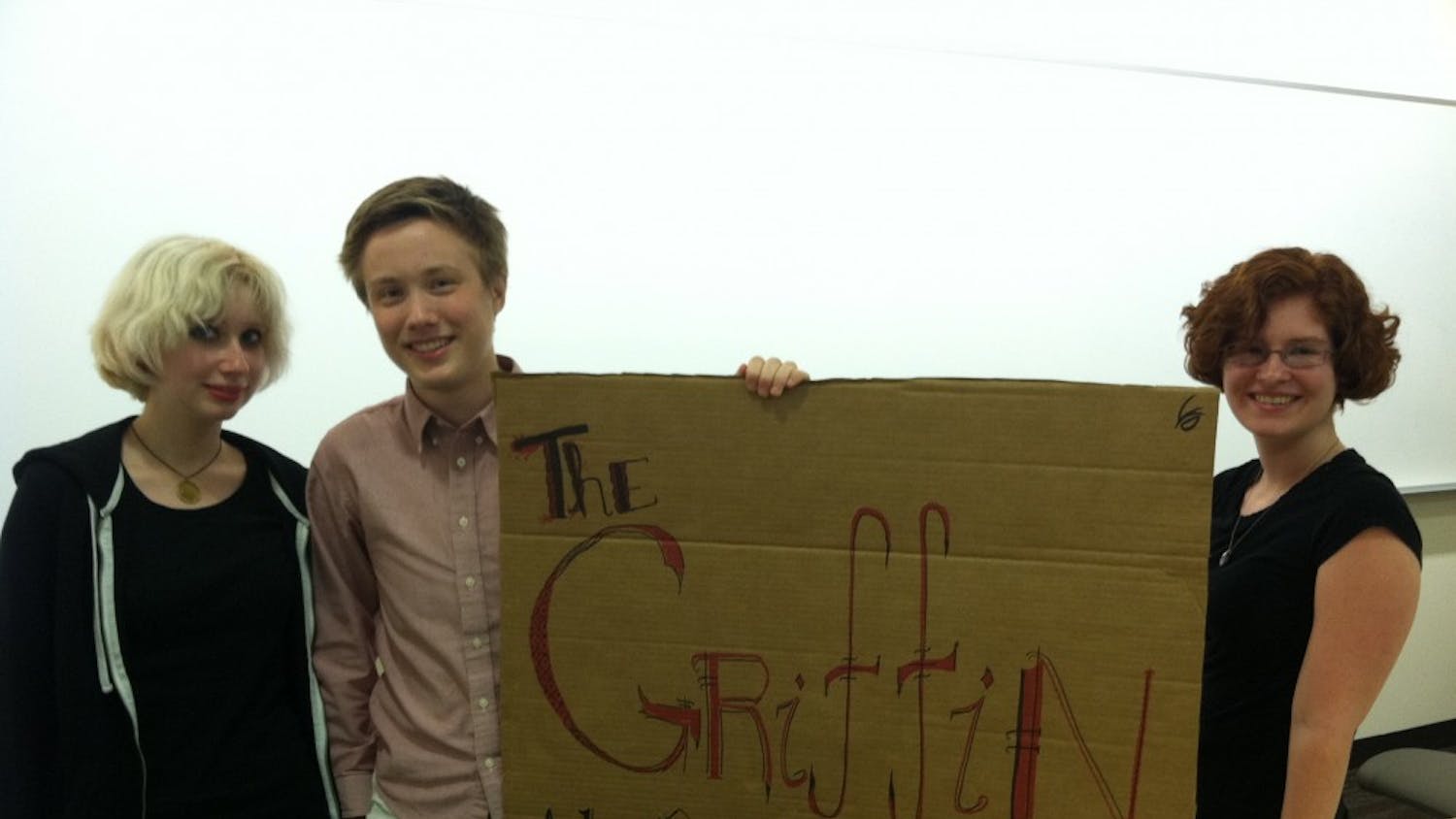	The Griffin&#8217;s Vice President Mariel Stratford, President Brendan Williams-Childs and Treasurer Caitlin Friess pose with a sign of The Griffin after its general interest meeting on Sept. 4.