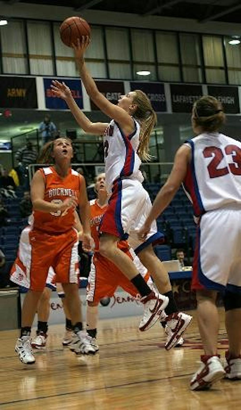 SO CLOSE - No. 23 Maggie Smith-Davidson watches No. 22 Liz Lear drive to the basket, but it was not enough to help the Eagles avoid their seventh straight loss on Wednesday night, losing to Bucknell by three in overtime.