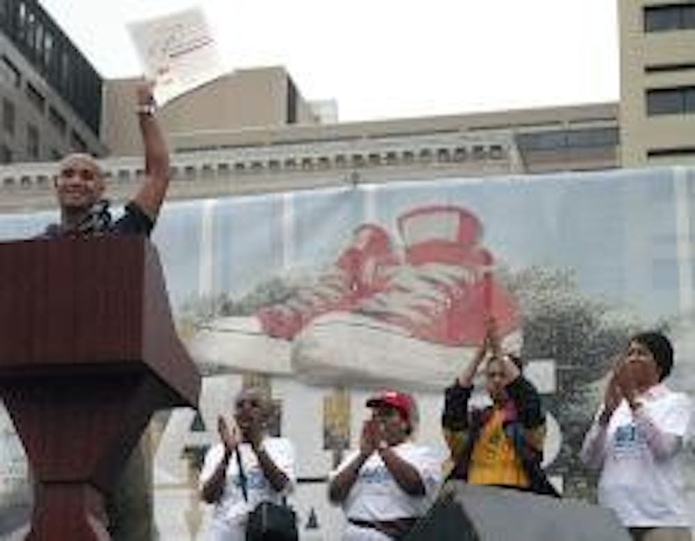 OFFICIAL FIGHT - Mayor Adrian Fenty speaks before a crowd at Freedom Plaza, raising high the proclamation document to create AIDS Awareness Day in the District. 