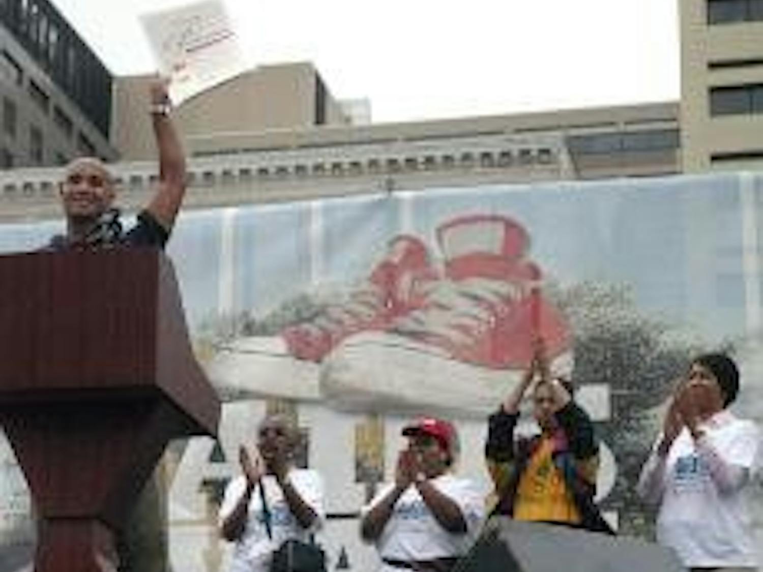 OFFICIAL FIGHT - Mayor Adrian Fenty speaks before a crowd at Freedom Plaza, raising high the proclamation document to create AIDS Awareness Day in the District.