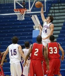 SLAMMIN' IT HOME-Senior forward Brian Gilmore (No. 14) finishes a slam-dunk in a recent Eagles' game this season, as No. 15 Frank Borden and No. 3 Garrison Carr look on.  Gilmore had 28 points in the AU's win over the Colgate Raiders on Saturday. 