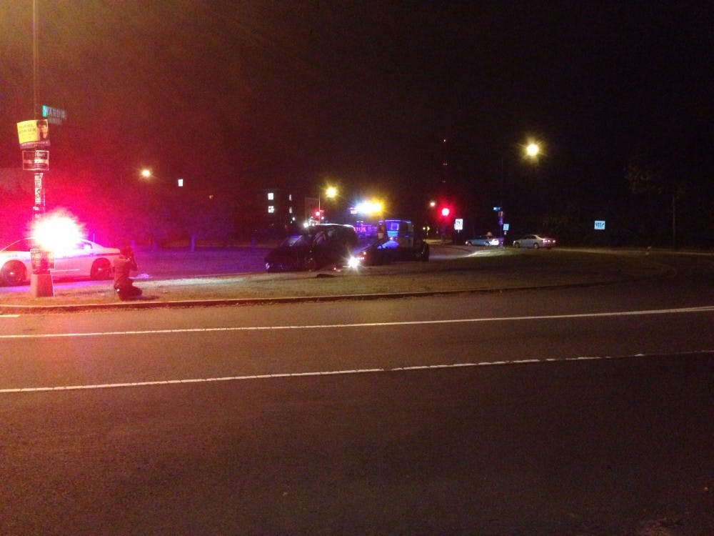 	A tow truck pulls a black SUV car involved in a single car accident.