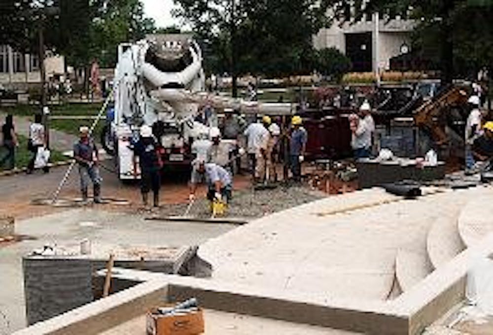BUILDING BRIDGES - Construction workers lay concrete in front of the entrance to Mary Graydon Center. The bridge between Mary Graydon Center, the main quad and Butler Pavilion will open this weekend. The university will close front entrance to MGC for two