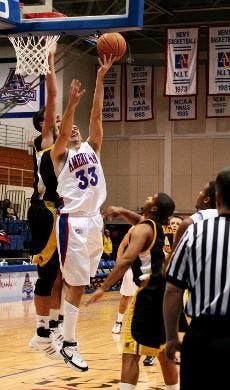 ONE-ON-ONE PLAY- Junior Bryce Simon's attempt at a basket is reflected by his close-playing UMBC opponent. Despite Simon's career high of 13 points throughout the game, the Eagles were unable to add another winning tally to their record books.  