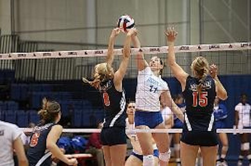 BLOCK SHOT - No. 11 senior setter Christina Nash rises up to block a shot against Bucknell University in the Patriot League semifinal match on Friday night.  The Eagles won their eighth consecutive league title this weekend, earning a spot in the upcoming