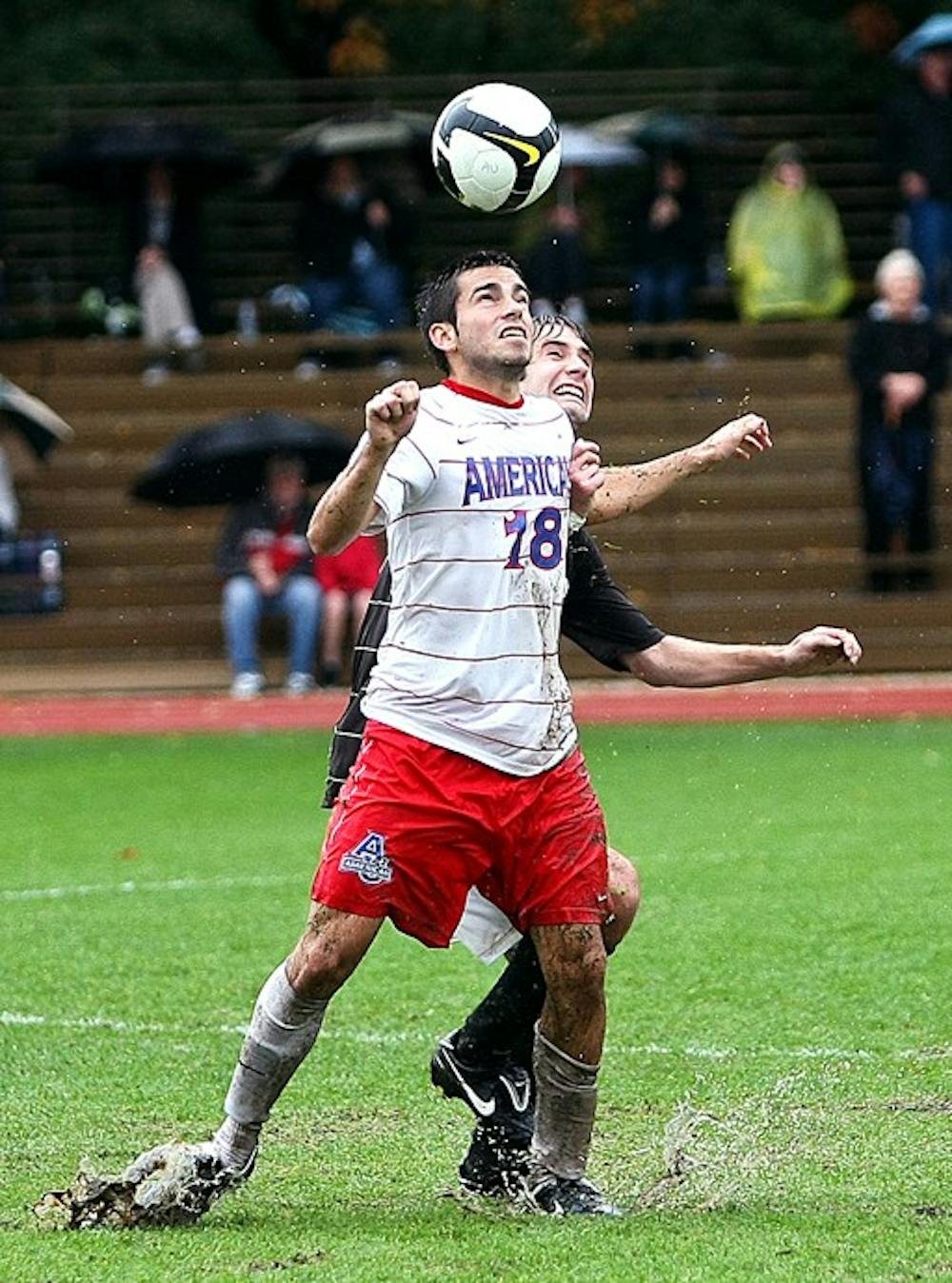 PLAYING IN THE RAINâ€”Senior Colin Zizzi heads the ball in AUâ€™s double overtime thriller. While the game was a draw, it still leaves the Eagles without a loss in the conference. Their next game is Wednesday at Georgetown. The men have a 8-3-2 record overall and 4-0-1 in the Patriot League.