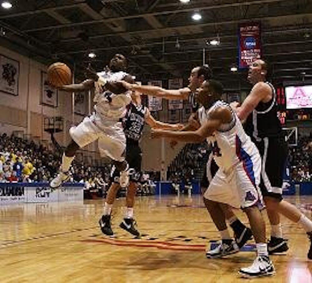 BENDER BREAK DOWN - Junior Derrick Mercer soars through the air on his way to scoring a lay-up during the Phil Bender game against the Holy Cross Crusaders on Saturday. 