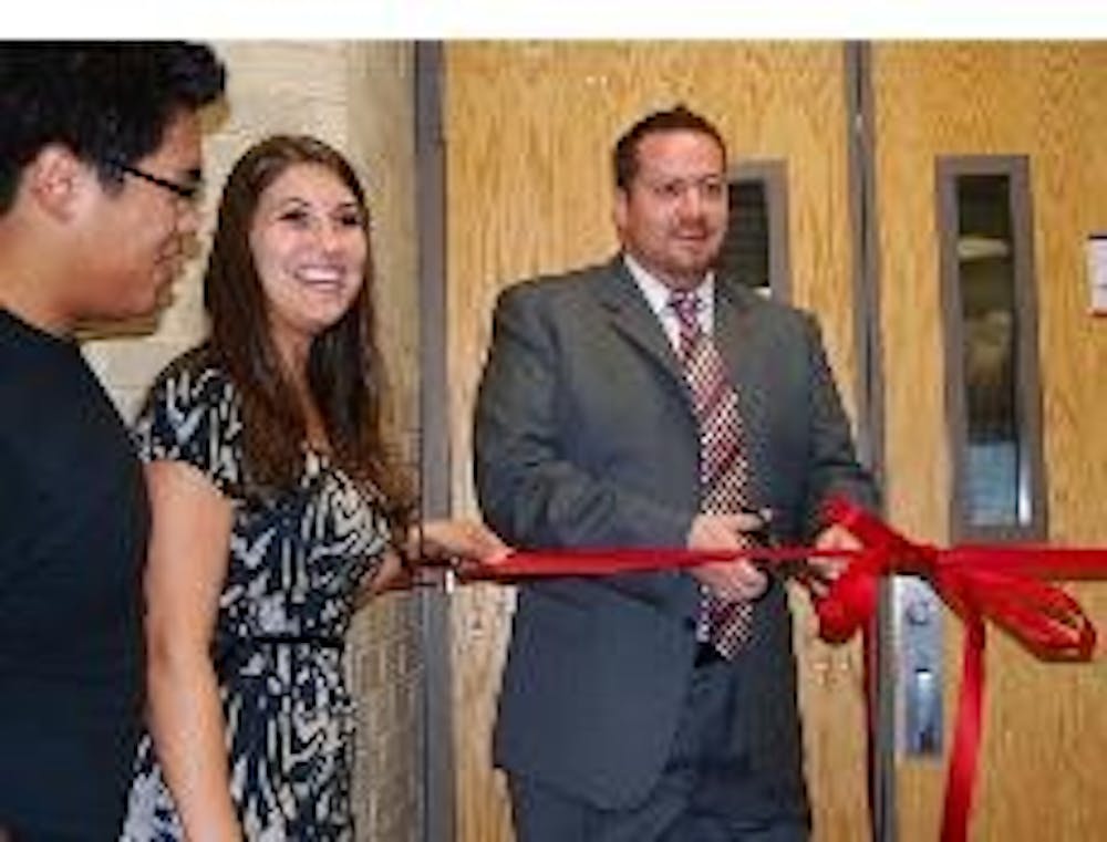 GRAND OPENING - Von Gerik Allena, Angela Nagy and Chris Moody help cut the ribbon to unveil renovations in Centennial Tuesday evening.