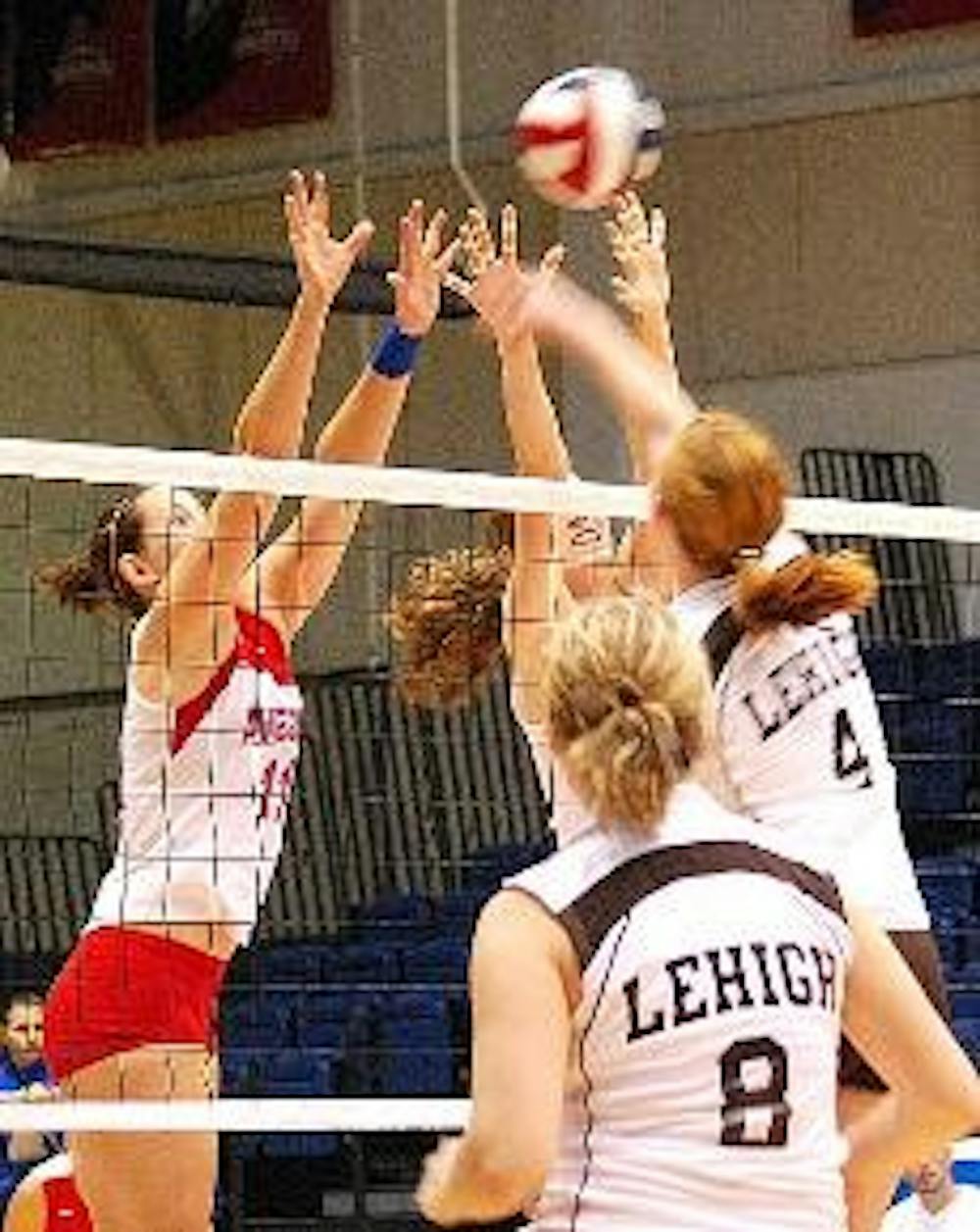 HANDS UP - Senior setter Christina Nash (No. 11) and junior middle blocker Claire Recht team up to block their Lehigh opponents in Saturday's 3-0 victory over the Mountain Hawks.  The Eagles have won five straight matches and 15 consecutive sets during th