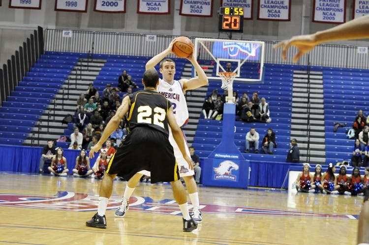 STARTING THE OFFENSE â€” Senior guard Steve Luptak looks to pass over opponent in Thursdayâ€™s exhibition game.