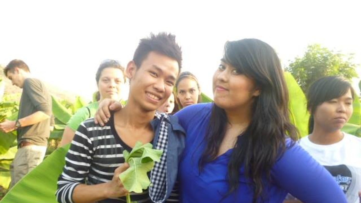 	Columnist Sarah Harvard (right) poses for a picture with a Burmese student (right) holding a radish.