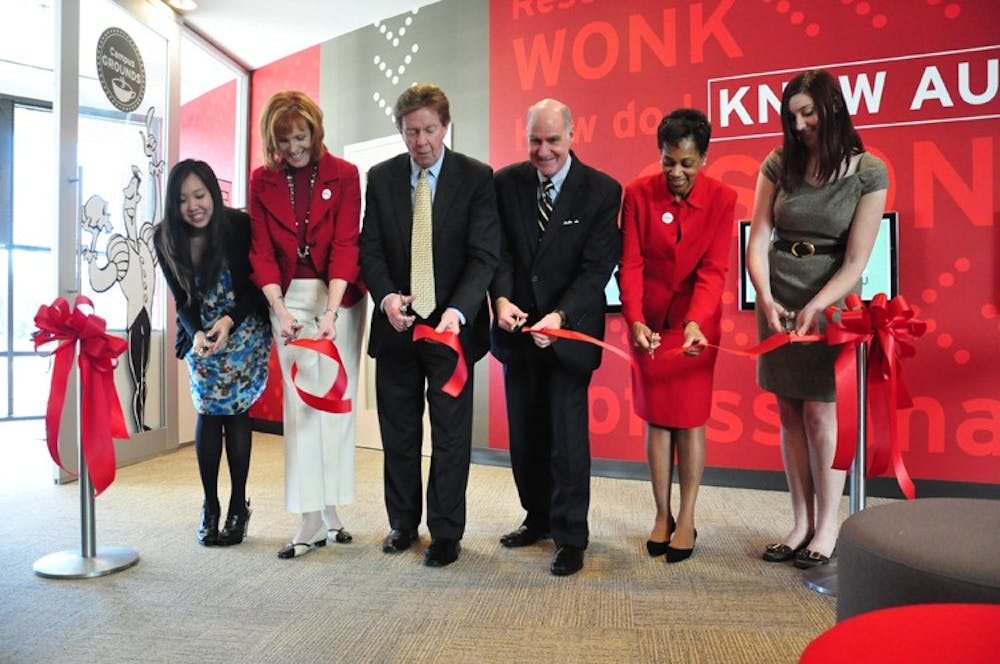 WELCOME WONKS â€” AU Ambassador Anj Lum (left), Executive Director of Communications and Marketing Teresa Flannery, President Neil Kerwin, Provost Scott Bass, Executive Director for Enrollment Sharon Alston and AU Ambassador Alisa Morse cut the new Admissions Welcome Centerâ€™s ribbon Feb. 14. 