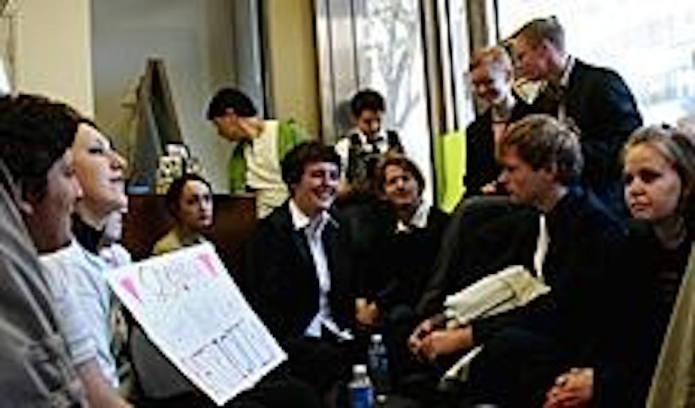 Alexandra Douglas-Barrera, center, and Mandy Craig, at right with glasses, sit in the recruitment center's lobby to protest "Don't Ask, Don't Tell."