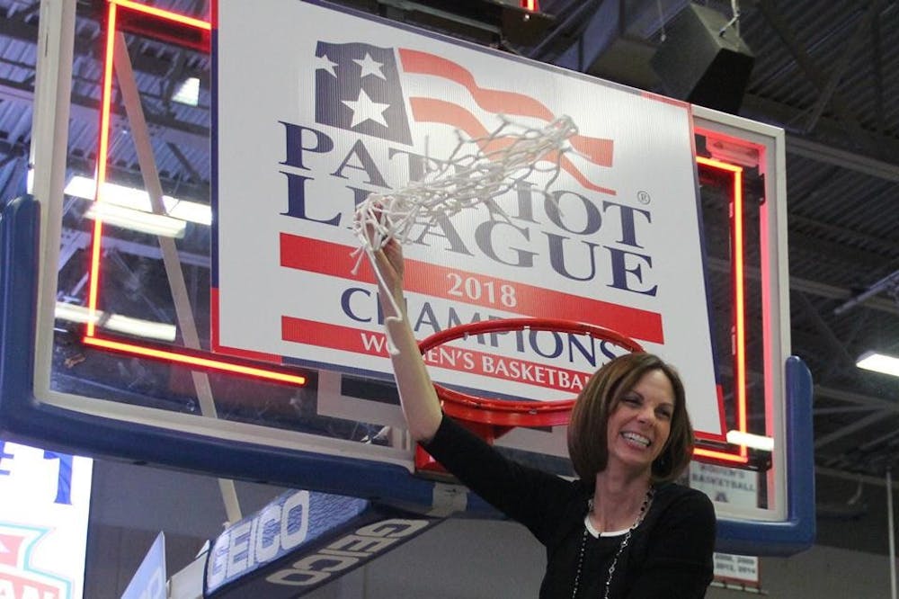 Women's basketball head coach Megan Gebbia cuts down the net after the Eagles victory over Navy in the Patriot League championship Sunday.