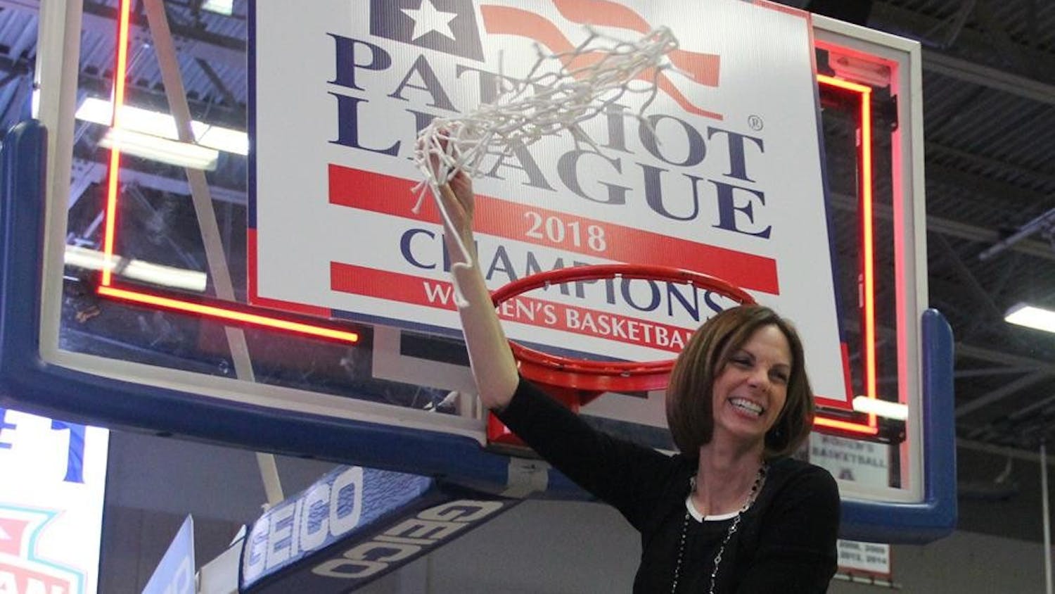 Women's basketball head coach Megan Gebbia cuts down the net after the Eagles victory over Navy in the Patriot League championship Sunday.