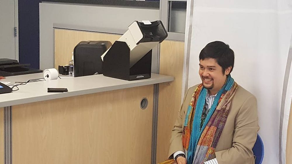 Nic Sakurai, an AU alum and adjunct professor, is pictured at the Department of Motor Vehicles as they register for their license on June 27.&nbsp;