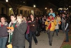 RAISING AWARENESS - AU students march past the Kogod School of Business during Take Back the Night Tuesday evening. The event, which also included time for people to give testimonials in Kay Spiritual Life Center, was held to raise awareness of domestic v