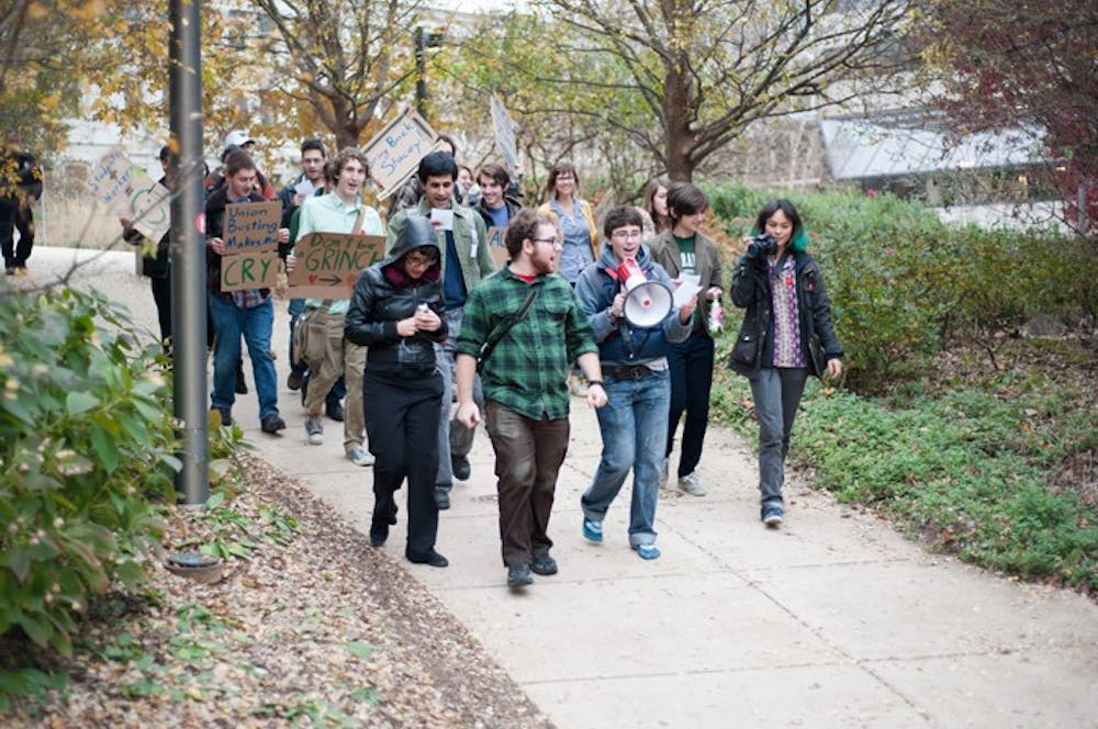 Members of the Student Worker Alliance march through the ampitheater to Provost Scott Bass\' office, chanting for the University to rehire Stacey Lucien, a secretary in the Department of Mathematics and Statistics. 