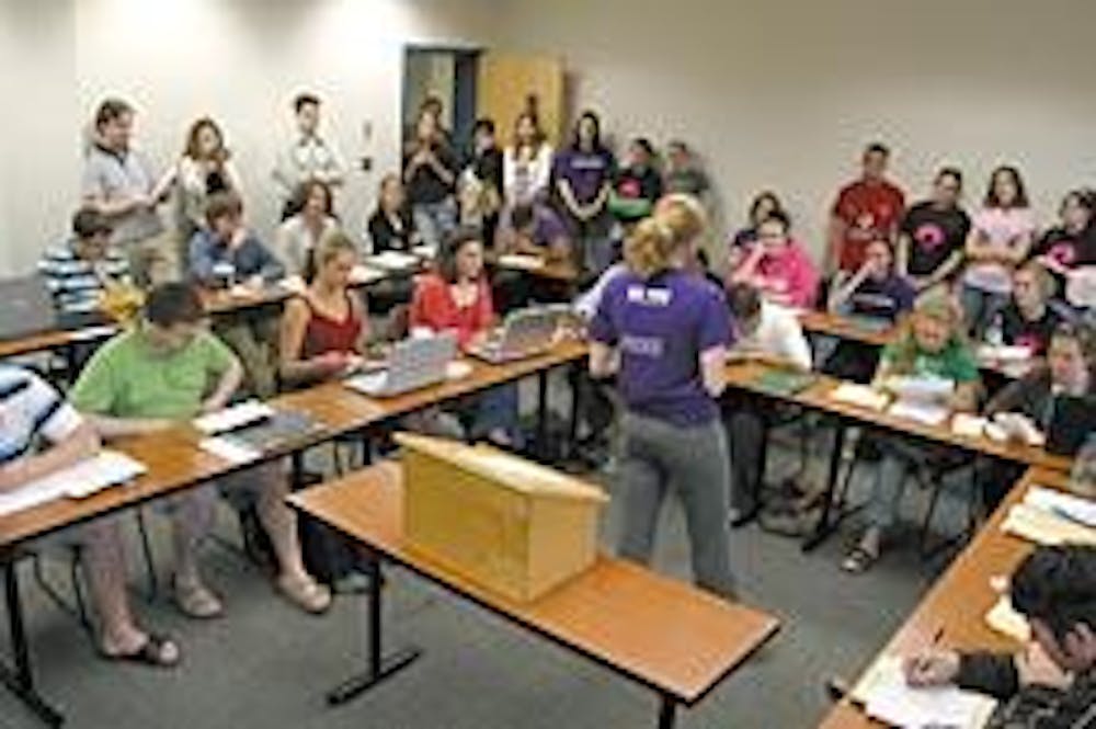 A member of Women's Initiative encourages the Student Senate to increase funding for the group. 