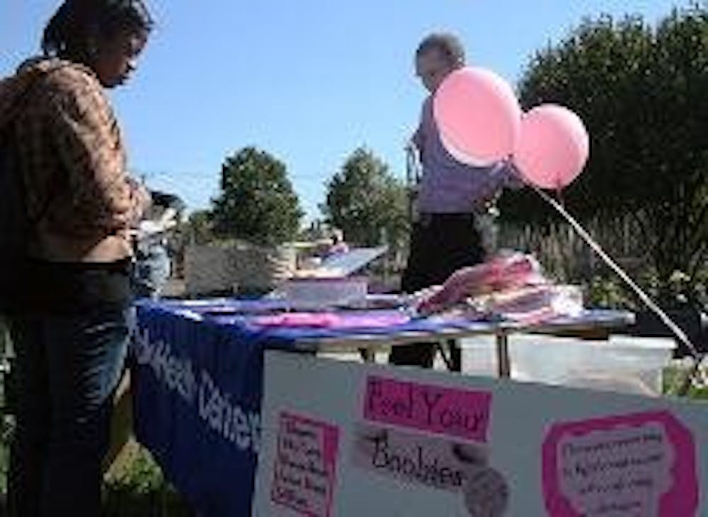 FEEL YOUR BOOBIES - AU students stop by a table at the Breastival to learn how to screen for breast cancer. The best to fight breast cancer is through early prevention, according to Student Health Center representatives.