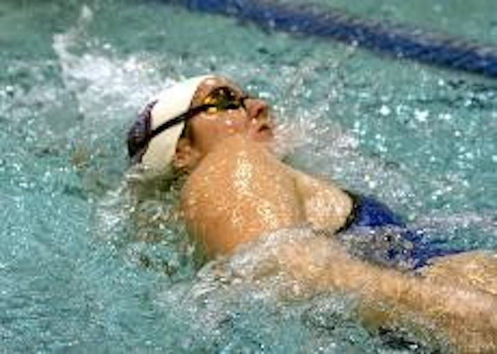 MAKING A SPLASH - Eagle swimmer Molly Bohmer competes in the 200-yard backstroke. The Eagles competed against neighboring schools George Washington University and Catholic University. The men and women recorded several victories in various events, includi
