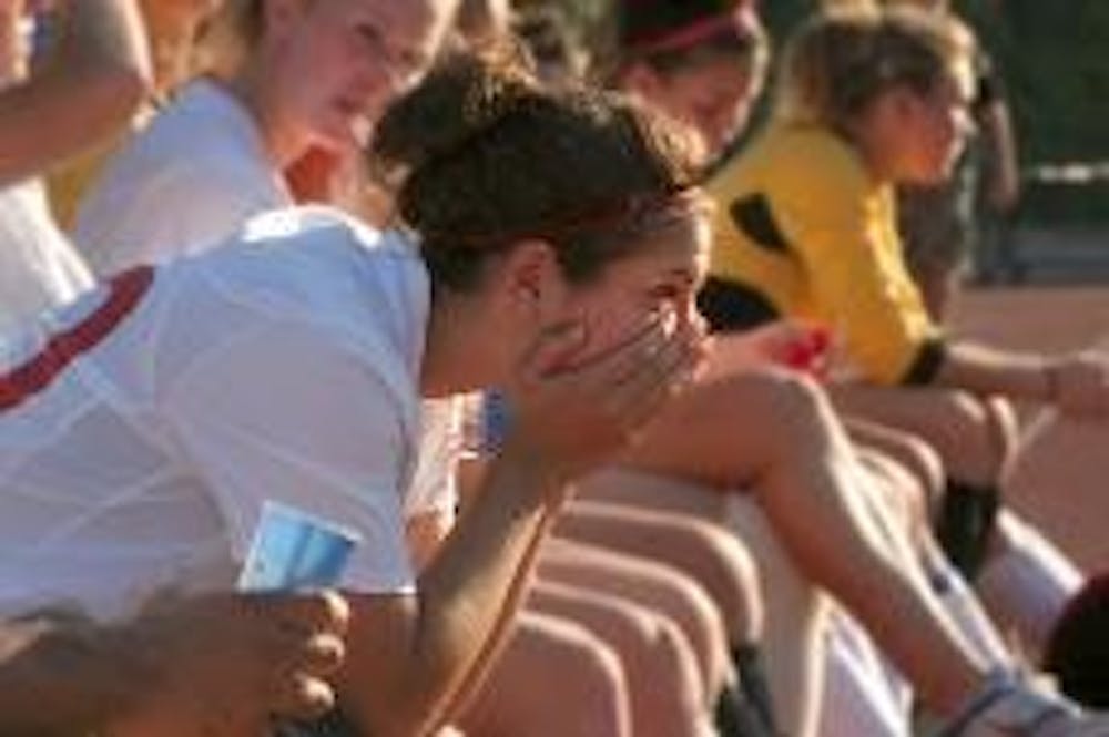 DEEP IN THOUGHT - Midfielder Margeau Faticone reflects on the game while supporting her team from the sideline. The Eagles put up a tough fight in the match against the George Washington University Colonials  in Tuesday's game. The team lost 1-0 in double