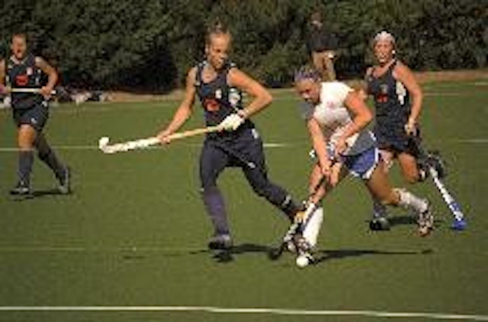 CUT THROUGH - Senior midfielder Megan Henry dribbles through three of her Bucknell opponents in their game this weekend.  Henry was instrumental in the teams success this weekend, scoring once to help the Eagles win over Bucknell and Towson.