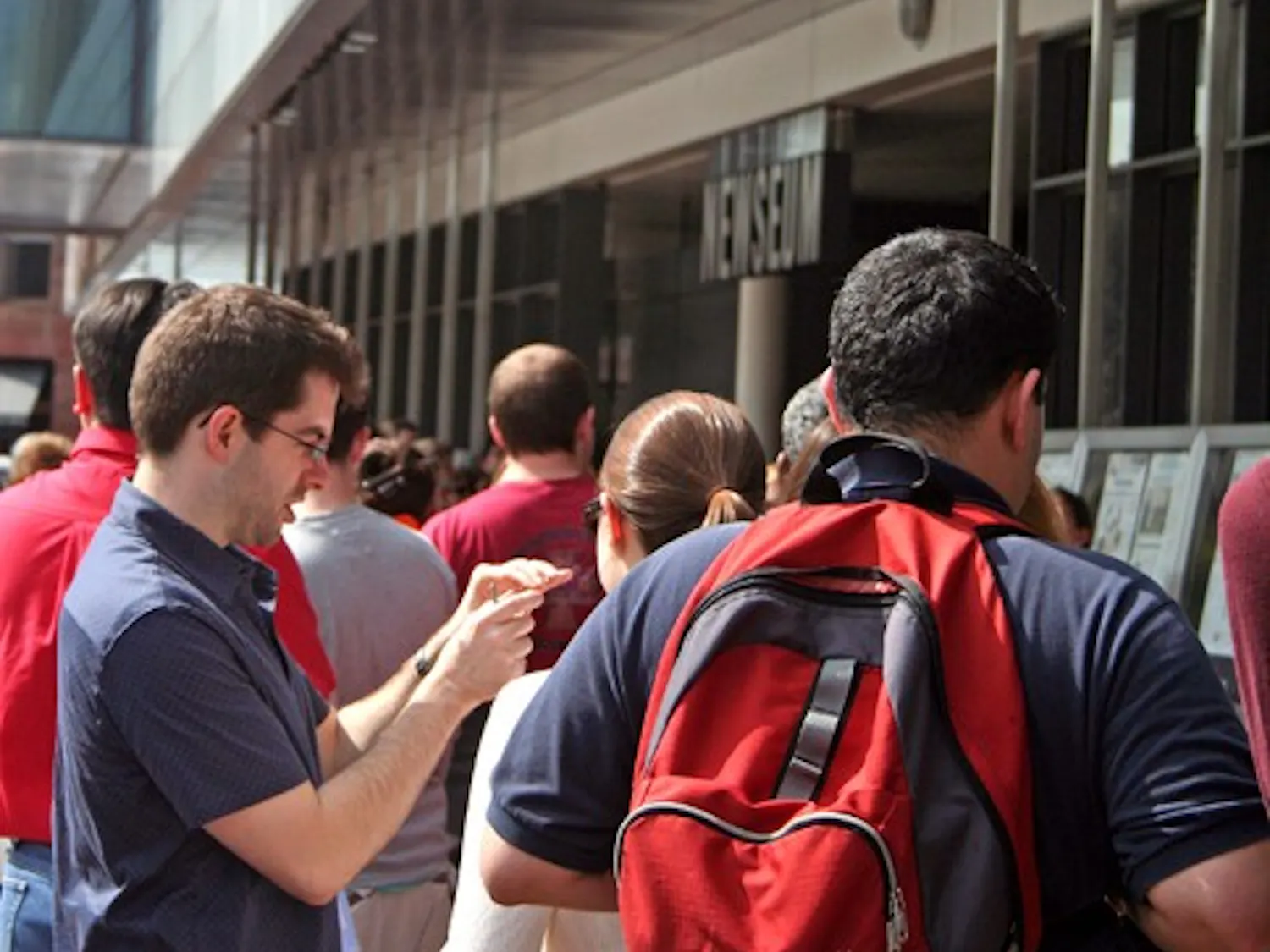 AROUND THE NATION IN 50 HEADLINES — Passers-by check out the Newseum’s outdoor display of front pages from newspapers around the country. The Newseum opened its D.C. location in April 2008.