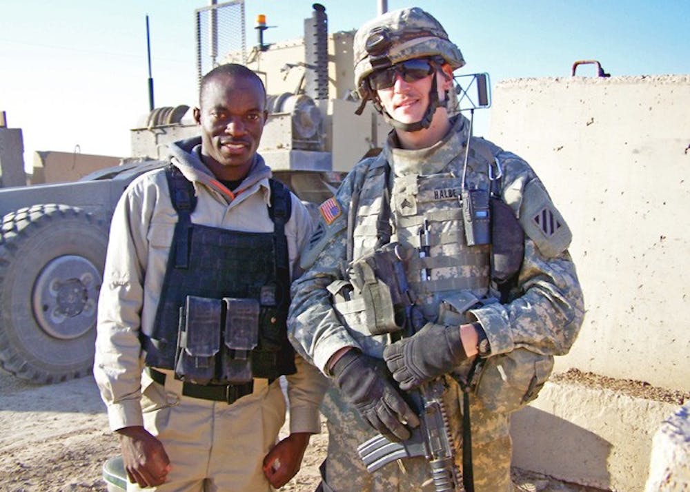 DIFFERENT WORLD â€” Matthew Halbe stands with Timothy, a friend of his from Uganda, in Camp Ramadi while he was serving in Iraq in late 2007. Halbe went to the â€œFunk the War: Bad Romance Street Partyâ€ partly out of curiosity but found the experience to be liberating.