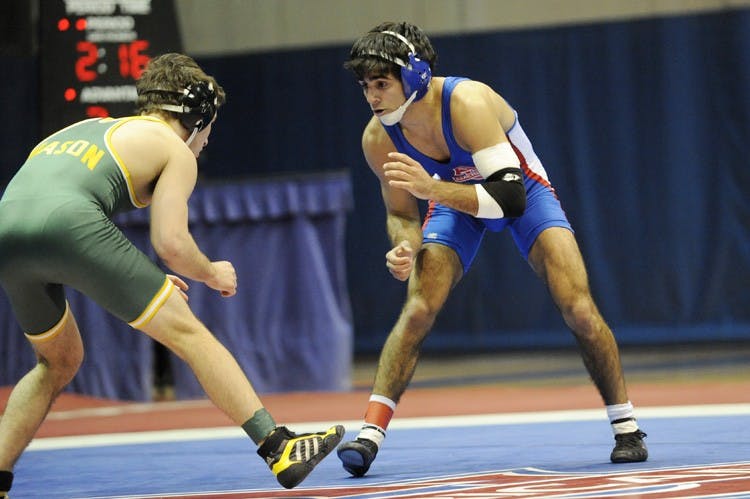 STAYING BALANCED â€“ Redshirt junior Matt Mariacher stares down his George Mason opponent in a match from last week. Mariacher is currently ranked 13th in the 141 pound weight class.
