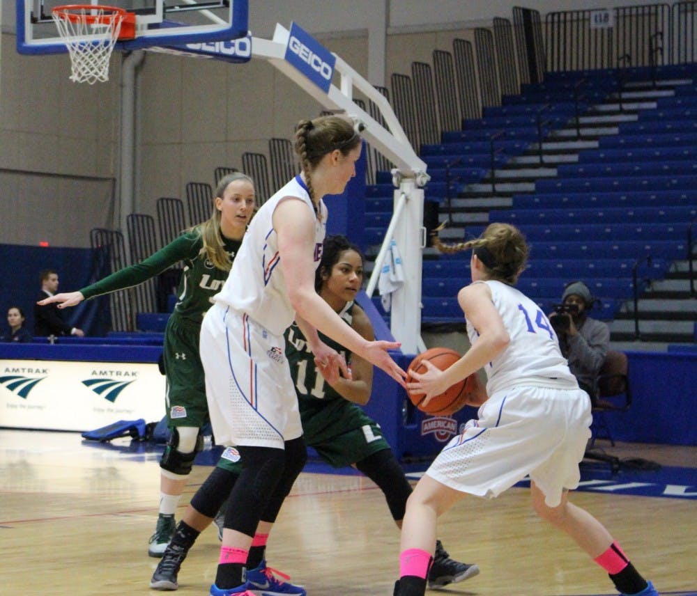 AU freshman Cecily Carl hands the ball off to sophomore Maria Liddane&nbsp;in a game against Loyola (Md.) on Feb. 27