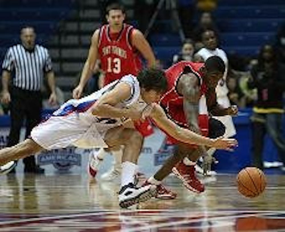 FULL COURT BATTLE - No. 15 Frank Borden (above) prepares to dive to the floor to battle for a loose ball while No. 44 Jordan Nichols (below) fights against his Red Flash opponent in the Eagles' 67-46 victory on Monday night. The Eagles also raised their 2