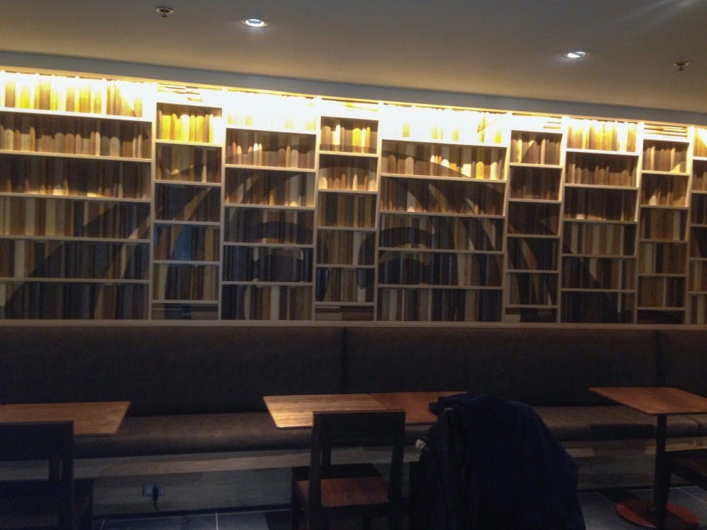 	A 3-D wall mural of decorative books line the back wall of the Starbucks where students can sit and study.