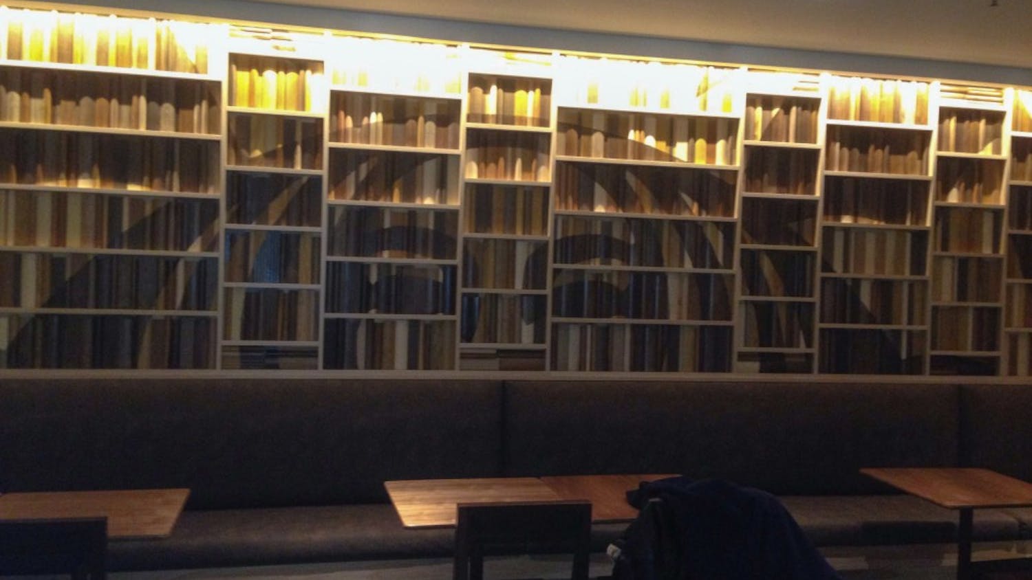 	A 3-D wall mural of decorative books line the back wall of the Starbucks where students can sit and study.
