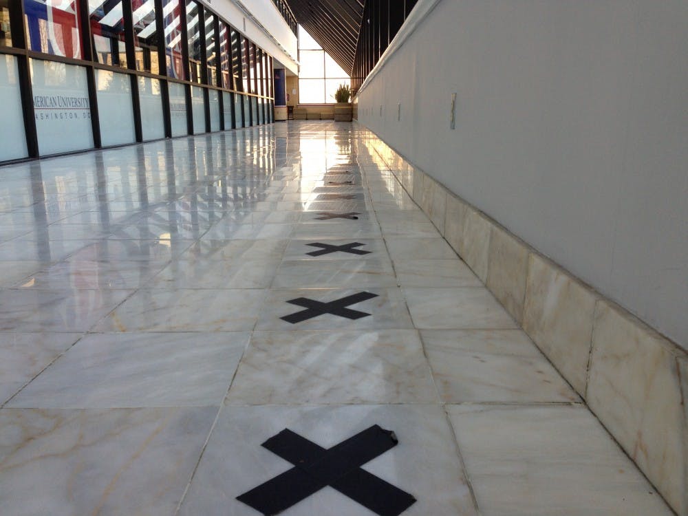 	A line of &#8220;x&#8220;s along the lower level of the AU Bookstore represent the 100 spots for Founder&#8217;s Day Ball ticket distribution.