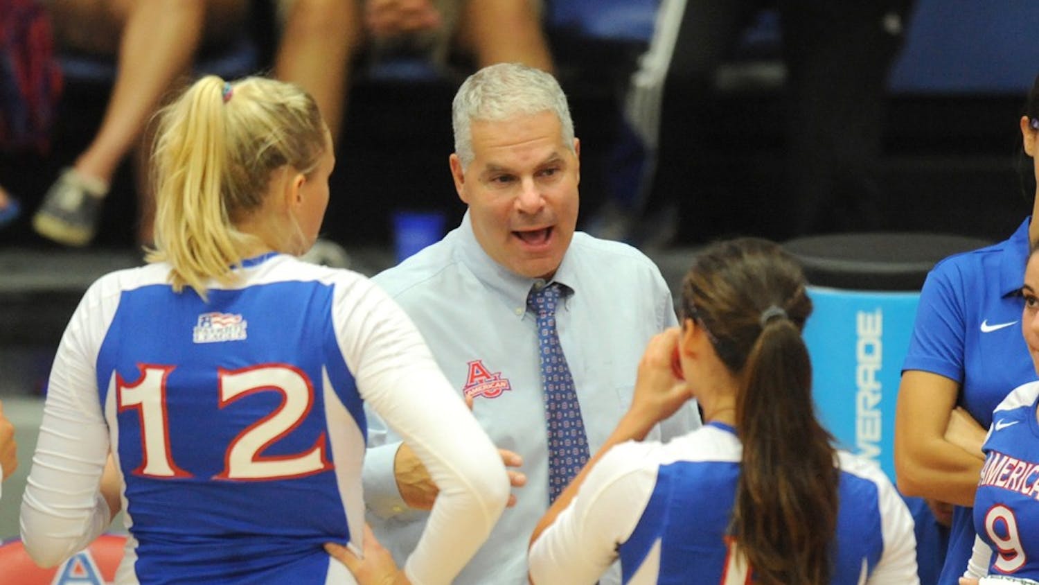 	Volleyball head coach Barry Goldberg chats to two players during an AU game.