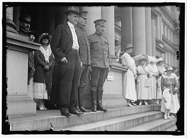 AU STEPS UP â€” Secretary of War Newton D. Baker, center left, and General Tasker H. Bliss, center, greet incoming students at a convocation ceremony.
